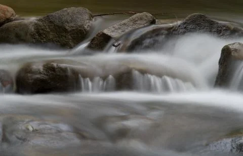 Water over rocks in the stream Stock Photos