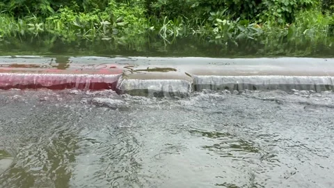 Water overflows from rivers, causing floods on the street Stock Footage 294854433