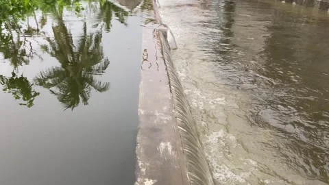 Water overflows from rivers, causing floods on the street Stock Footage 294854505