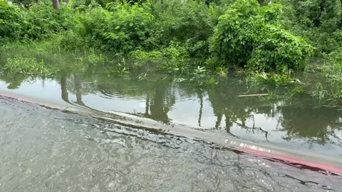 Water overflows from rivers, causing floods on the street Stock Footage 294854614