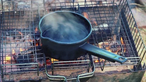 Water in a pan on fire Stock Footage 197543897