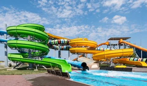 Water park, bright multi-colored slides with a pool. A water park without peo Fotos de archivo