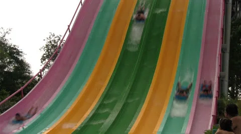 Water Park Guests Racing Down Colorful Speed Slides (with Sound) Stock Footage 25997877