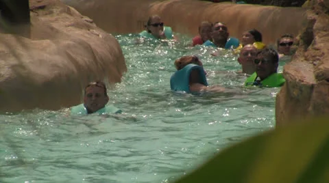 Water Park Visitors Flowing Down a Lazy River Video stock 24985916