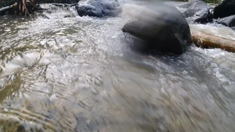 Water passing over rocks in the river Stock Footage 303761714