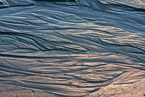 Water patterns on sand Stock Photos