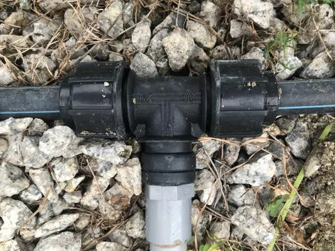 Water pipe connector on the ground. Selective focus Stock Photos