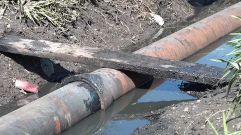 Water pipe in a dirty ditch Stock Footage 114804481
