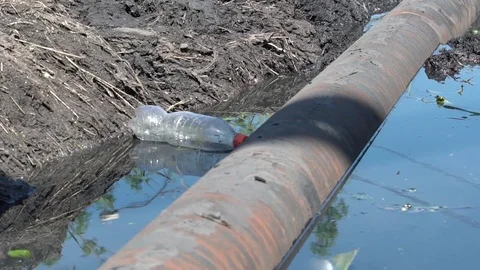Water pipe in a dirty ditch Stock Footage 114804491