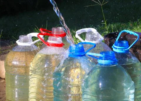 Water into plastic bottles Stock Photos