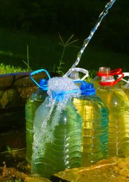 Water into plastic bottles Stock Photos