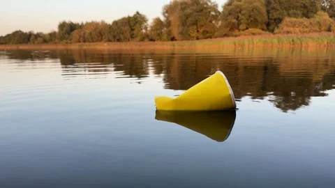 Water pollution. Coffee paper cup Garbag... | Stock Video | Pond5