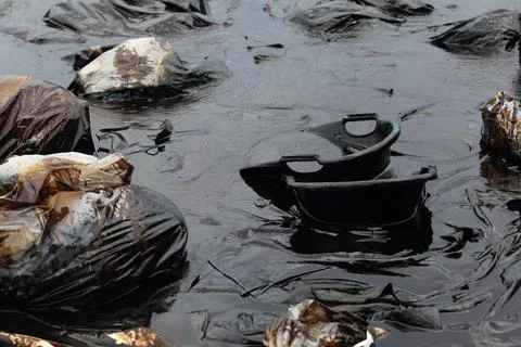 Water pollution - old garbage and oil Stock Photos