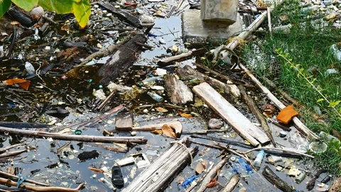 Water pollution problem Garbage floating in the river the problem is caused b Stock Footage 106701788