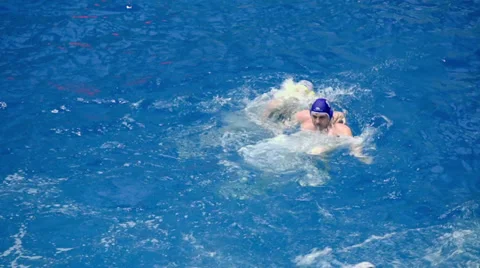 Water polo player struggles and score goal during game in basin Stock Footage 32152576