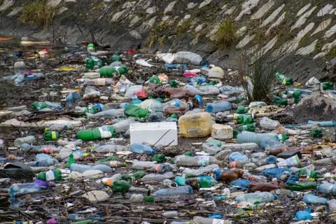 Water polution. Plastic and other residues thrown into the water. Stock Photos