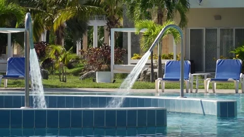 Water pool deck jet with strong stream of water in swimming pool in Cuba Stock Footage 301508389