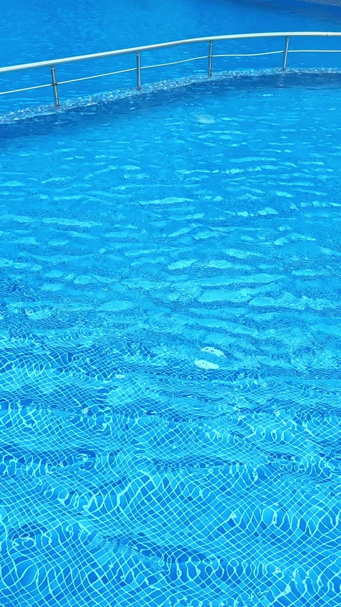 Water in a pool reflects sunlight and shows patterns of light and movement at a Stock Footage 340877683