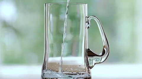Water is poured into the beer mug. Stock Footage 77729098