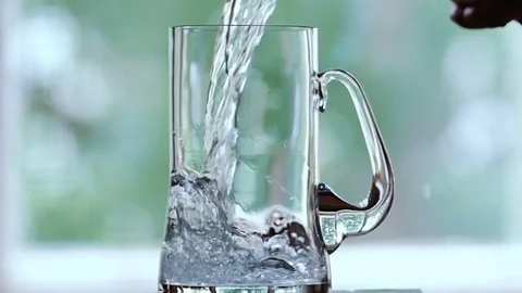 Water is poured into the beer mug. A tablet drops into the beer mug with water. Stock Footage 77732733