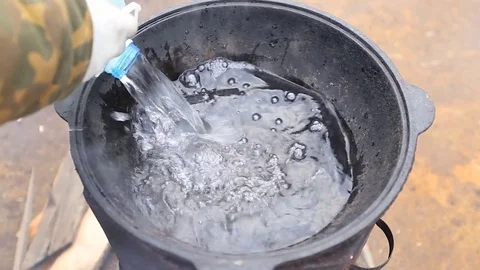 Water is poured into the cauldron Stock Footage 76082741