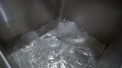 Water is poured into the container Stock Footage 148464276