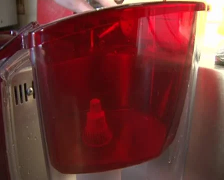 Water is poured into the filter Stockbeeldmateriaal 8837081