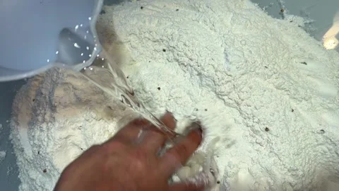 Water is poured into the flour Stock Footage 221201702