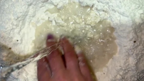 Water is poured into the flour Video stock 221201732