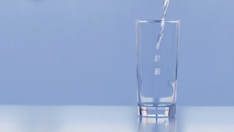 Water poured into glass Slow Motion Stock Footage