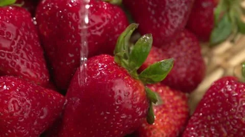 Water poured over fresh strawberries Stock Footage