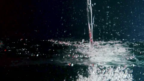 Water is poured into a tank with air bubbles in red Vídeo Stock 303475475