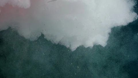 Water is poured into a tank with air bubbles in red light with drops Vídeo Stock 303475596