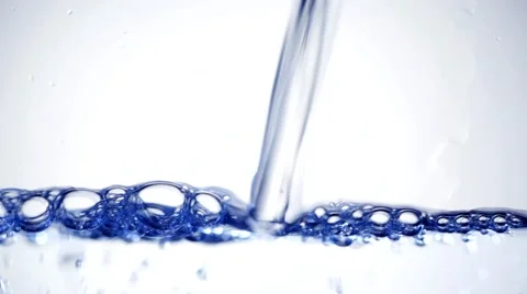 Water is poured on a white background close-up Stock Footage 40983992