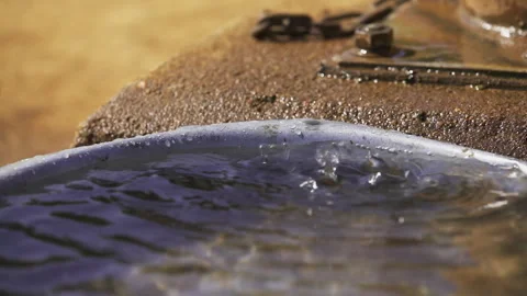 Water is pouring into container Stock Footage 256885466