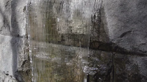 Water pouring down a stone in slow motion Video stock 141286908