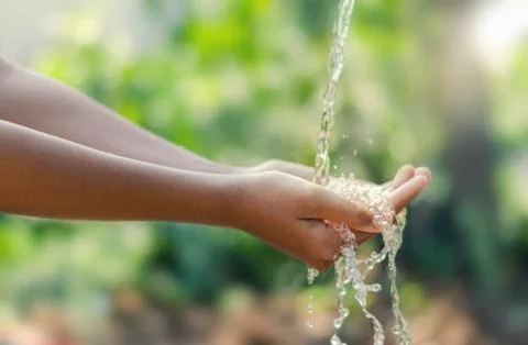 Water pouring in kid two hand on nature background Stock Photos