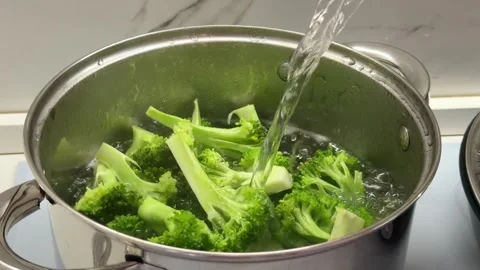 Water Pouring Over Fresh Broccoli in Cooking Pot Stock Footage 341111390