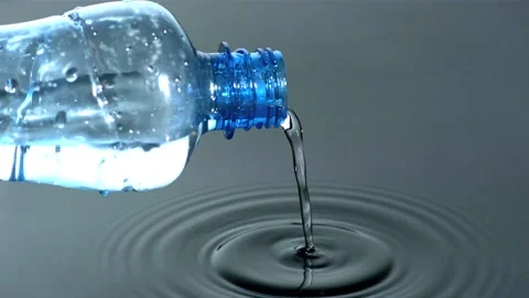 Water pouring from plastic bottle into pool Stock Footage 217430851