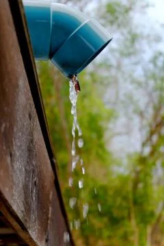 Water pouring from a rain gutter Stock Photos