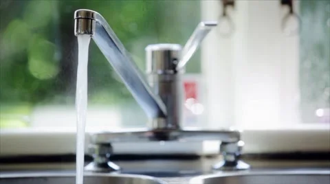 Water pouring from tap in kitchen. Stock Footage 8693034