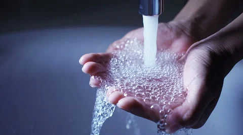 Water pouring in woman's hands. Stock Footage 61920209