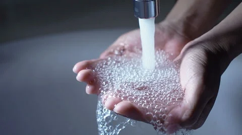 Water pouring in woman's hands. Stock Footage 61920358