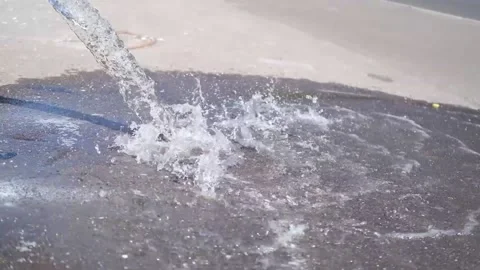 Water pours on asphalt Stock Footage 201600415