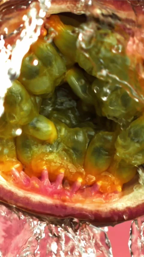 Water pours onto the cut passion fruit. Filmed on a high-speed camera at 1000 Stock Footage 335322695