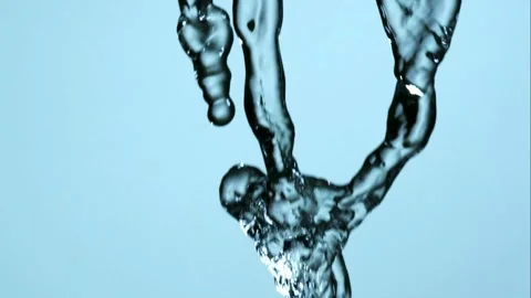 Water pours down and splashes into a wide liquid shape Video stock 326628216