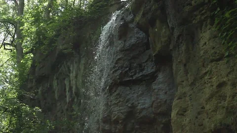 Water Pours Down Cliff Face Handheld Stock-Footage 106675071