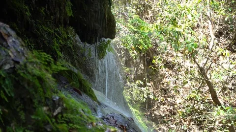 Water Pours Down the Side of a Rock Formation on a Mountain in Thailand. Stock Footage 74292117