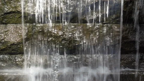 Water pours down a stone in 4K Stock Footage 141285699