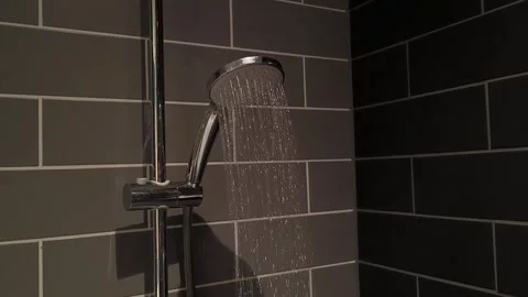 Water pours from a silver shower head Video stock 313793839